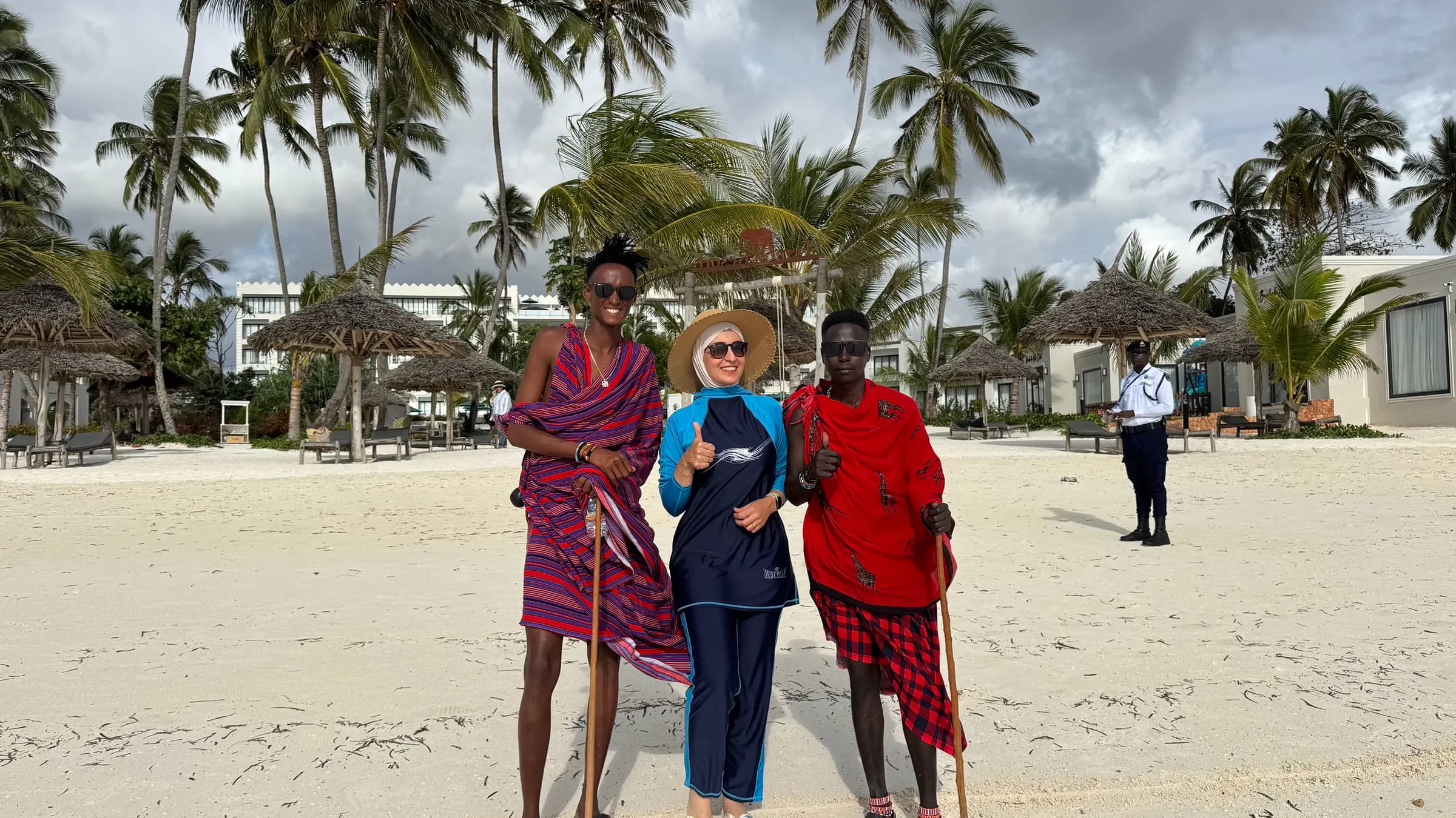 Travellers with Maasai hosts on a Zanzibar beach